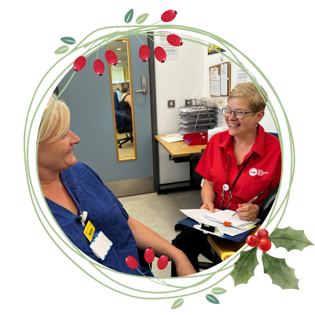 Circle image showing an ECLO chatting to a NHS member of staff. Surrounding the circle is a Christmas wreath.