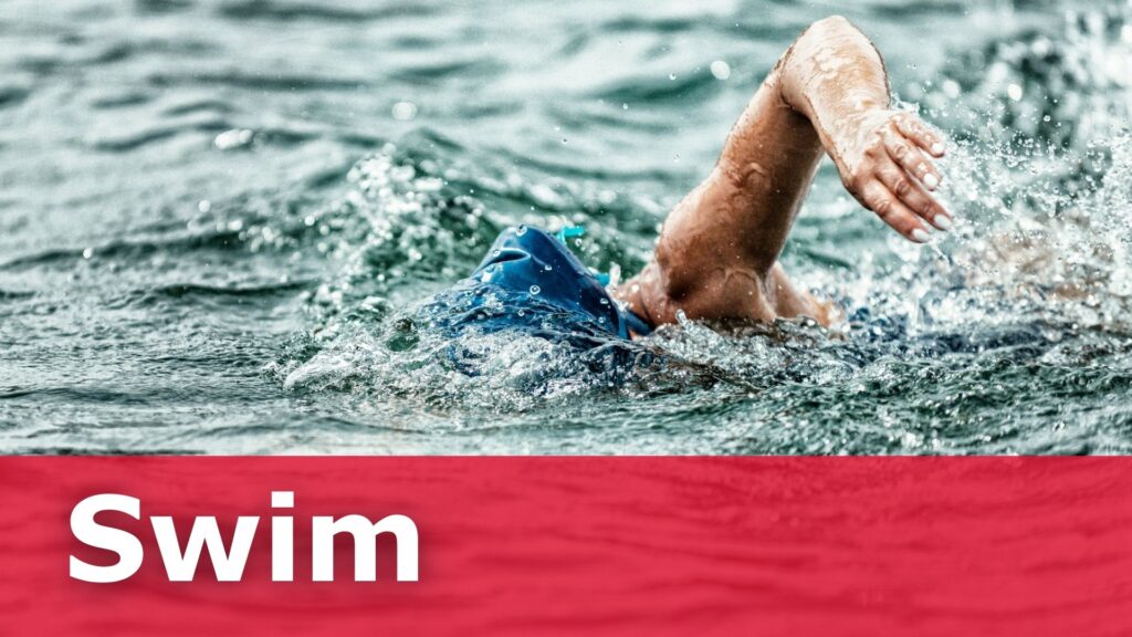 A lady swimming in a lake.
