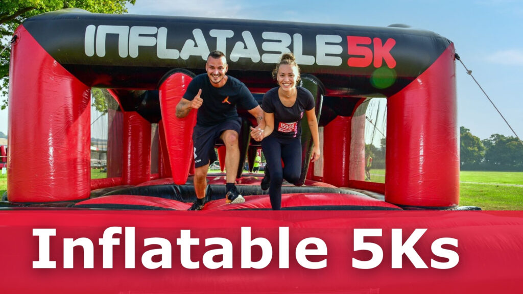 Two people running through a giant inflatable obstacles with tunnels.