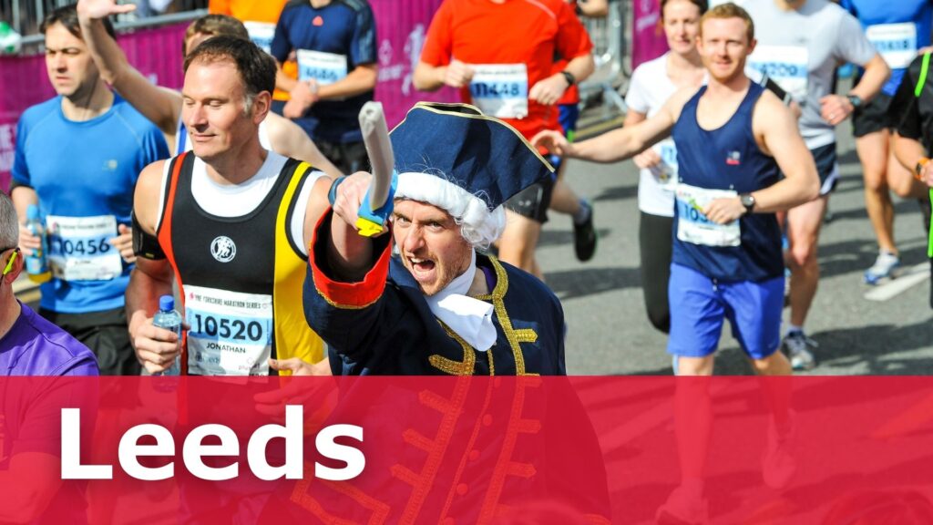 A group of people running, with a man dressed as a soldier wielding a pretend sword.