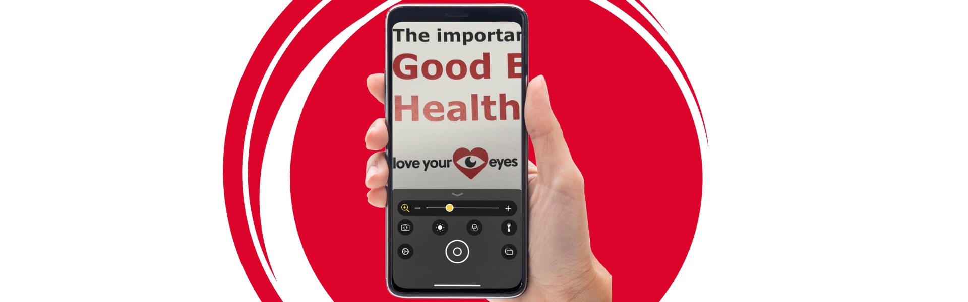 cut out close up image of a person holding an iphone with the magnifier on display and zoomed in on the KAB Good Eye Health leaflet