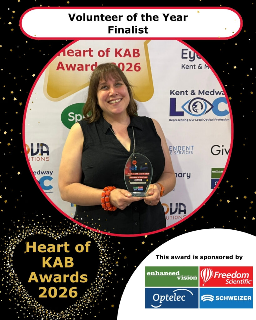 Ellen, volunteer counsellor, smiles with her trophy as finalist.